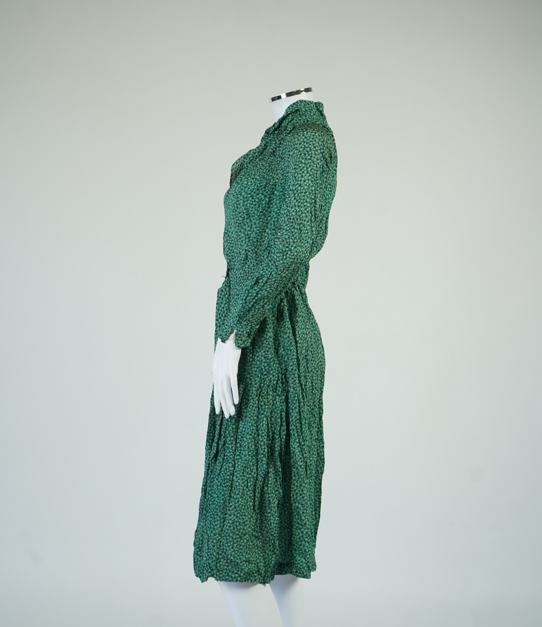Two 1930's printed silk crepe summer day dresses together with a similar pale blue and black stripped summer day dress., Condition - the maroon and cream dress has damage to one sleeve, the green dress has worn under the